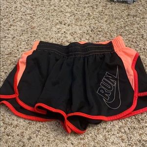Black, light pink, and dark pink nike shorts